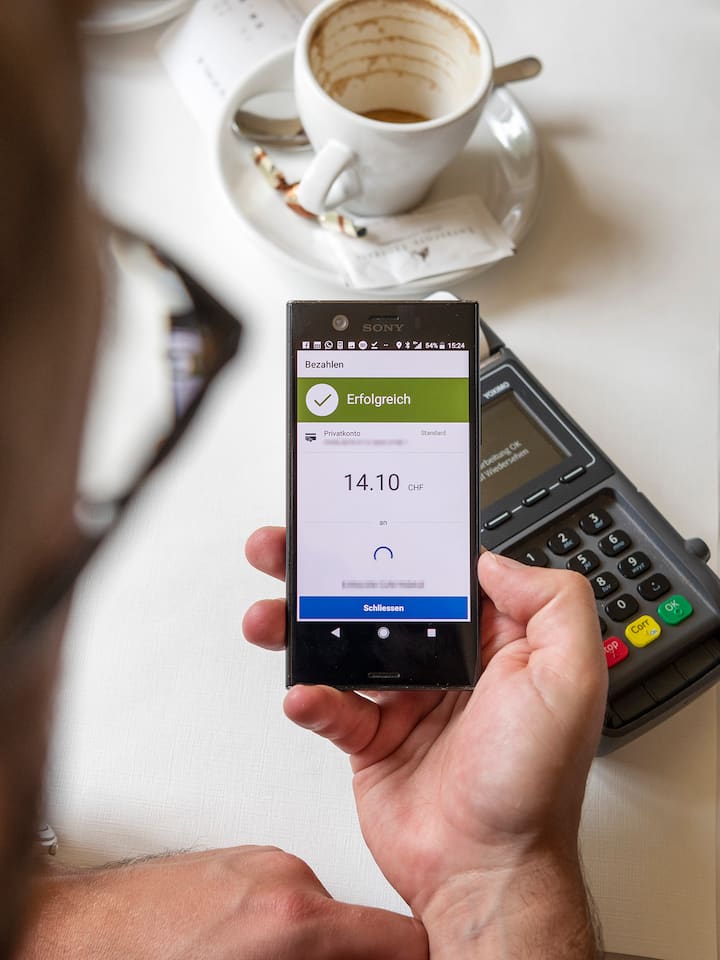 Wo Twint aussetzt – während Apple Pay funktioniert Handy mit Twint-App und Kaffeetasse - Besonders im Zug oder im Supermarkt ein bekanntes Problem: Ist das Mobilfunknetz schlecht, kann Twint ausfallen